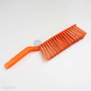 Orange cleaning <em>brush</em> with plastic handle