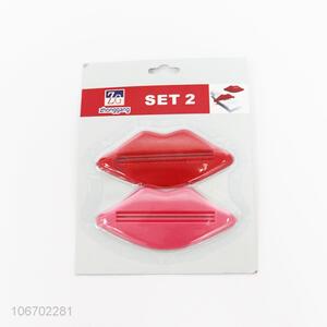 Newly designed 2pcs red lip shaped plastic toothpaste dispenser