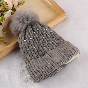 China imports winter knitted cap pom pom beanie hat for women